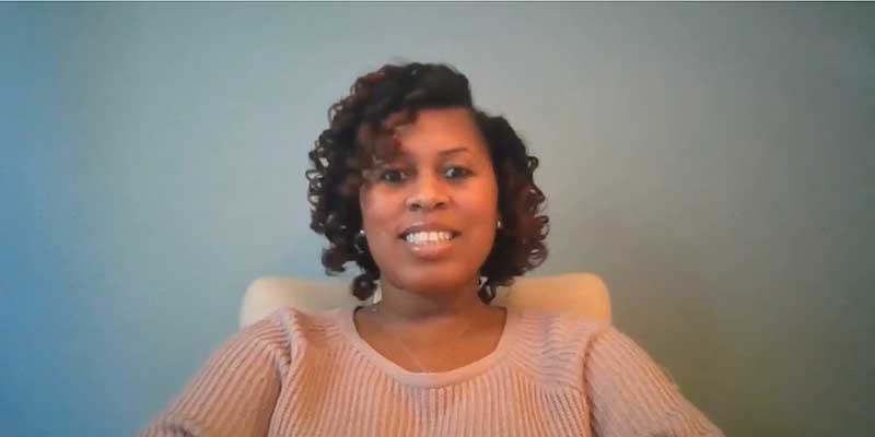 Woman sitting in a chair for Black History Month Video Cover